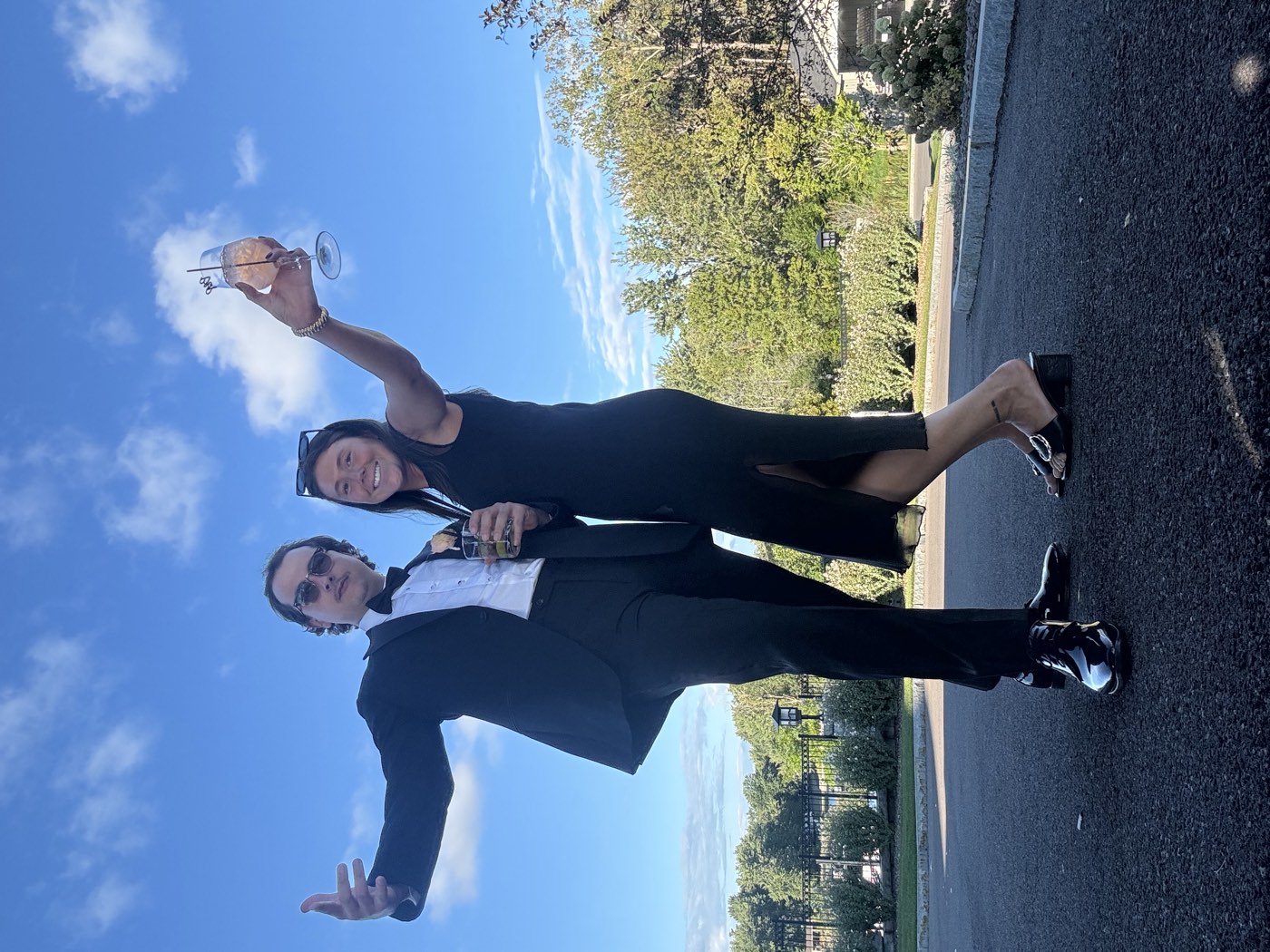 Catie and Joe dressed up and raising a toast at a wedding